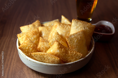 Brazilian snack Mini pasteis . Deep fried pastry. Traditonal food pastel.