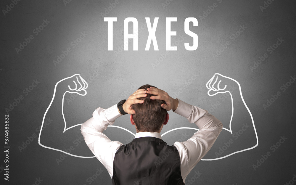 Rear view of a businessman with TAXES inscription, powerfull business concept