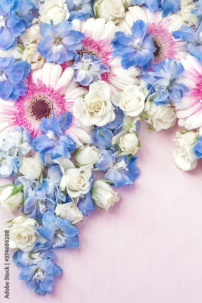 Close-up composition with a different flowers roses, gerberas and Delphiniums. Many beautiful fresh flowers on a table. Pastel colors. Natural background. Close-up composition with a different flowers roses, gerberas and Delphiniums. Many beautiful fresh flowers on a table. Pastel colors. Natural background.
