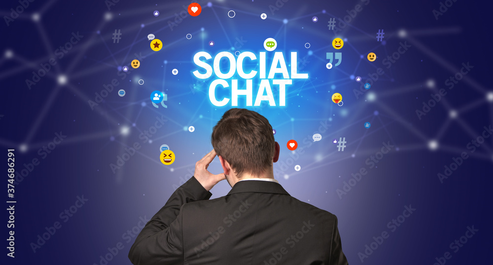 Rear view of a businessman with SOCIAL CHAT inscription, social networking concept Rear view of a businessman with SOCIAL CHAT inscription, social networking concept