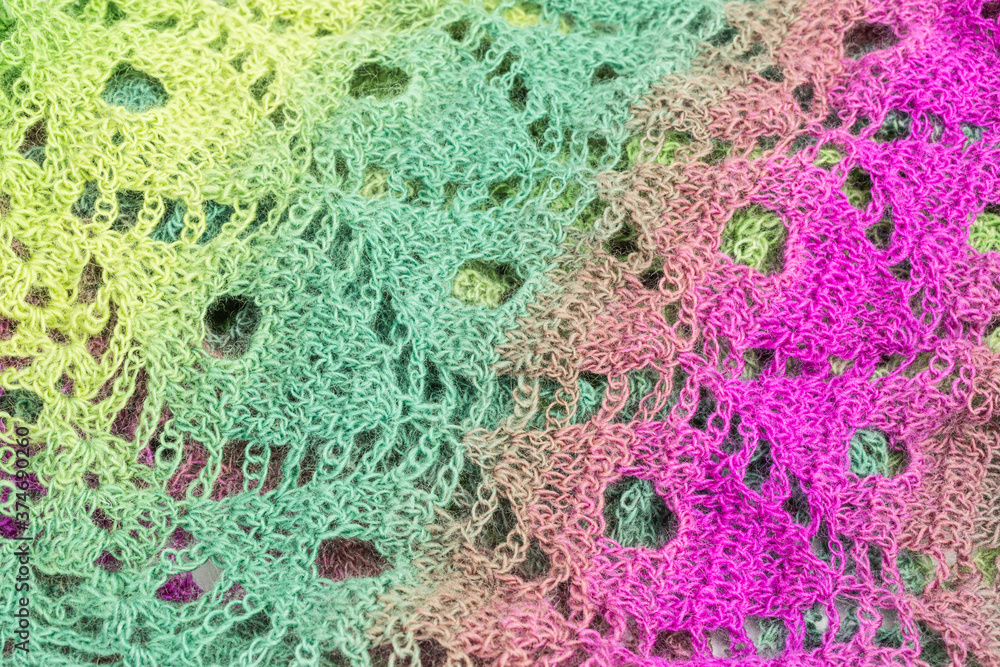 handmade multicolor crochet background in green and purple with double crochet stitches and chain stiches