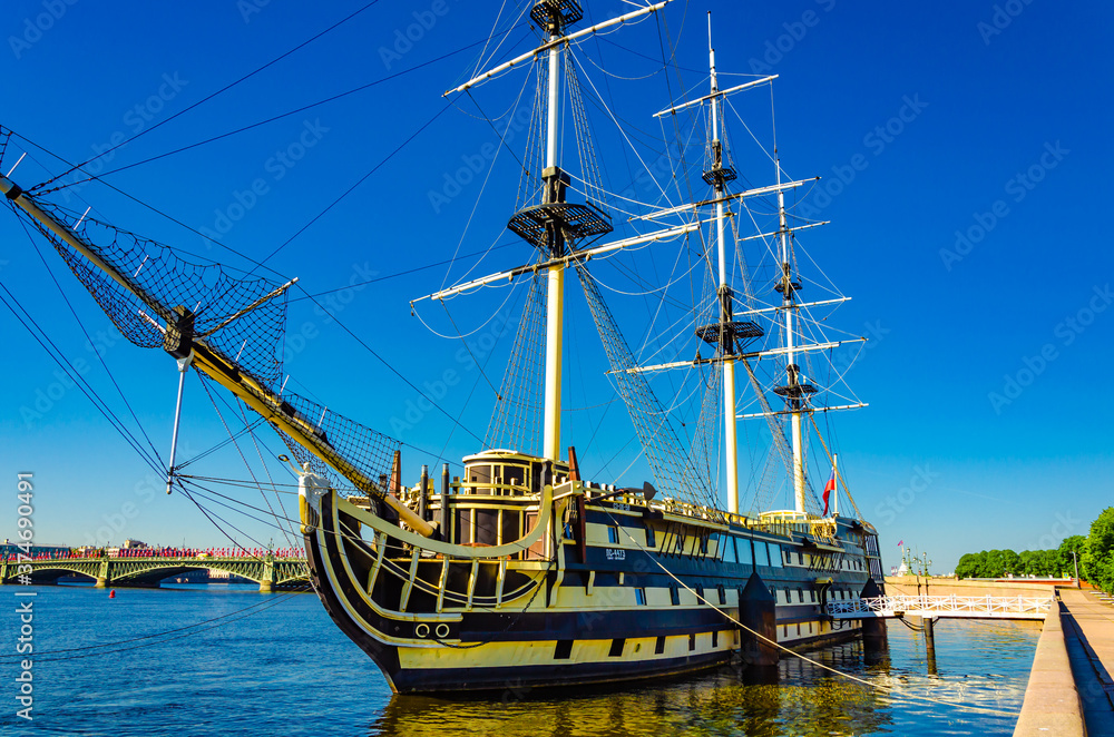 Old sailing boat on the river Bank at the pier.