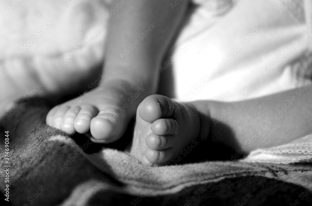 Close-up infant childlegs, black and white photo Close-up infant childlegs, black and white photo