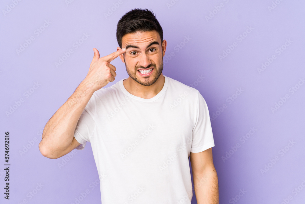 Young caucasian man isolated on purple background showing a disappointment gesture with forefinger. Young caucasian man isolated on purple background showing a disappointment gesture with forefinger.