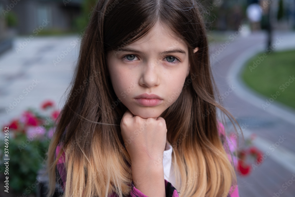 street portrait of a young sad girl, teenager. Sad face of a child street portrait of a young sad girl, teenager. Sad face of a child