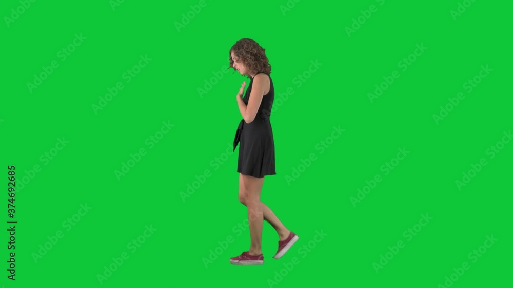 Ill young woman coughing and sneezing suffering flu or grippe. Full body side view on green screen chroma key background. Ill young woman coughing and sneezing suffering flu or grippe. Full body side view on green screen chroma key background.