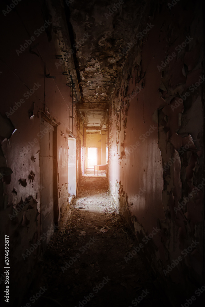 Dark creepy empty corridor of abandoned industrial or office building