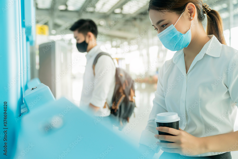 asian female business trip white cllar shirt self passport check in with automatic machine airport terminal safety travel concept new normal lifestyle