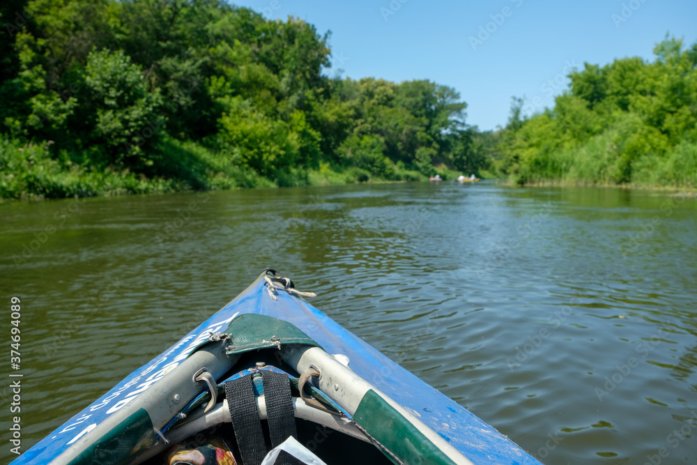 Fototapeta premium View from the blue kayak on the river banks