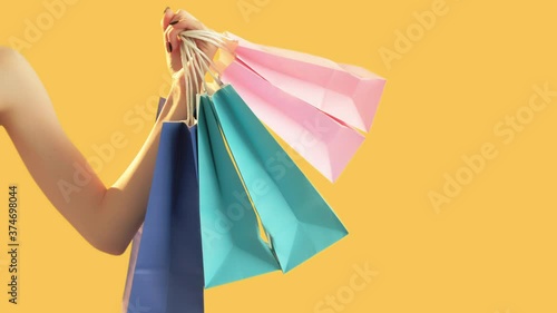 Shopaholic lifestyle. Black friday. Woman counting many shopping bags. Isolated on orange. Online sale. Black friday. Gifts for holidays photo