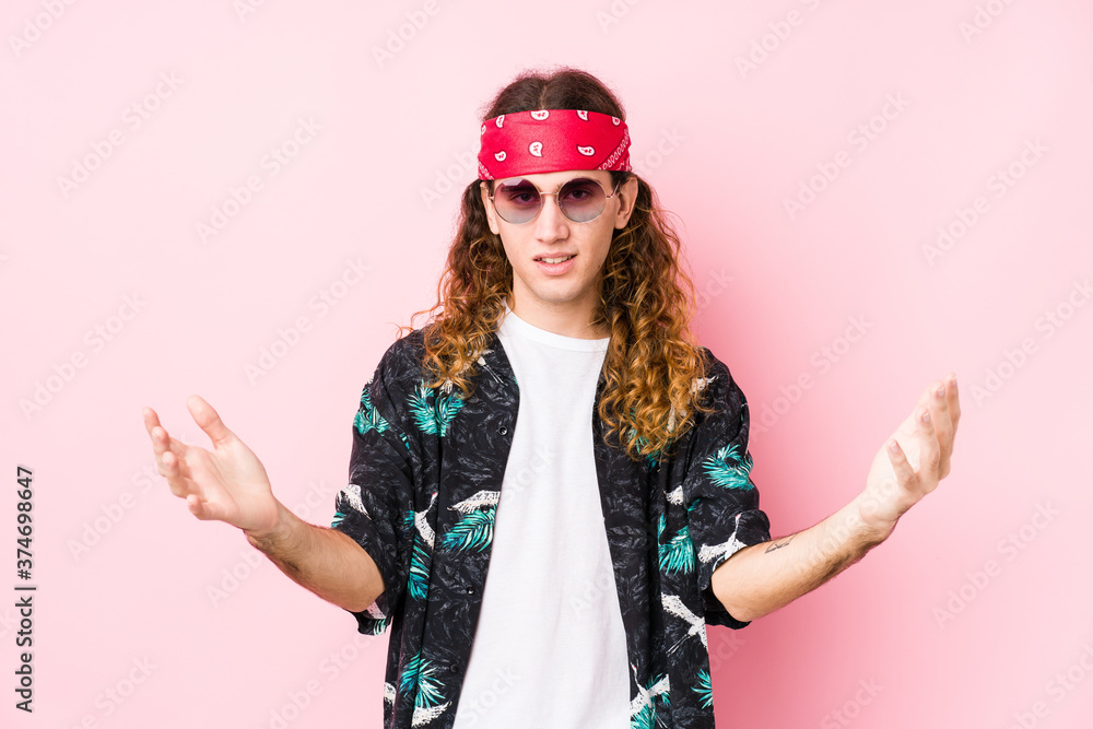 Young hippie caucasian man isolated feels confident giving a hug to the camera. Young hippie caucasian man isolated feels confident giving a hug to the camera.