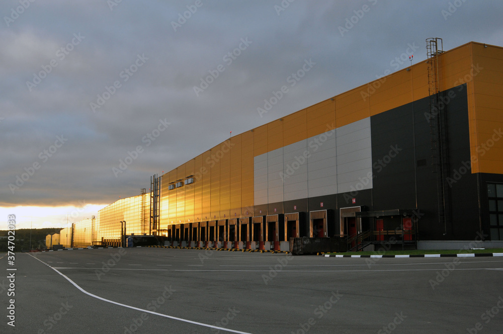 Warehouse logistics complex in the rays of the rising sun. Warehouse logistics complex in the rays of the rising sun.
