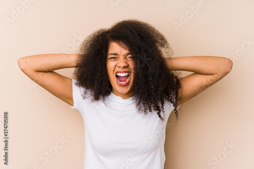 Young african american woman covering ears with hands trying not to hear too loud sound.