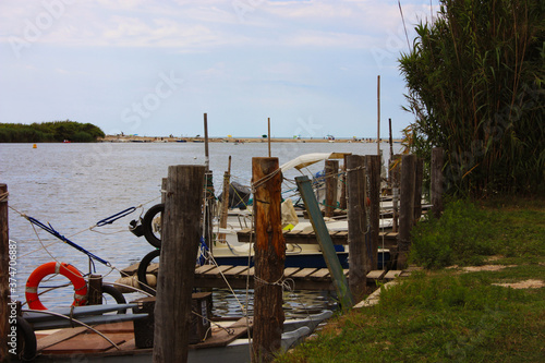 rustic craft marina on a swampy river where small boats moor in the green jungle photo