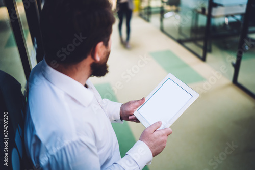 Anonymous businessman using tablet with blank screen