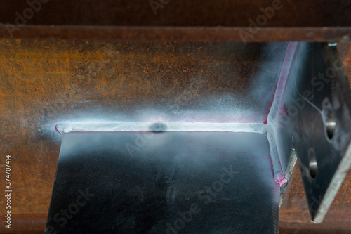 Fototapeta Naklejka Na Ścianę i Meble -  After use Developer spray into the welded to pull the liquid penetrate from the defect for Non-Destructive Testing(NDT) of welding with process Penetrant Testing or Penetration Testing(PT).