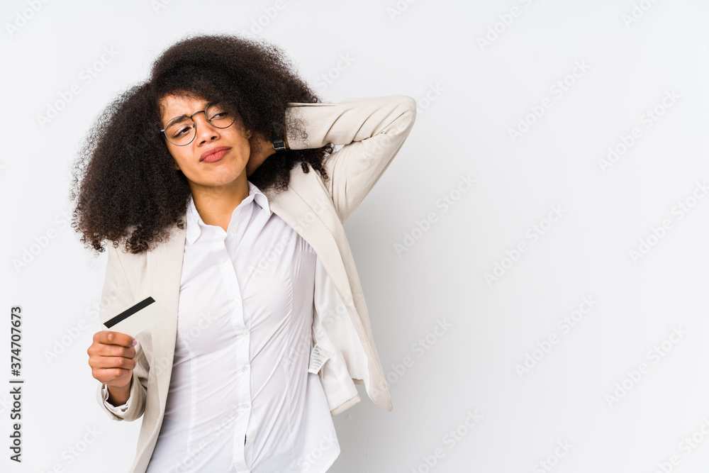 Young afro business woman holding a credit car isolated Young afro business woman holding a credit cartouching back of head, thinking and making a choice. Young afro business woman holding a credit car isolated Young afro business woman holding a credit cartouching back of head, thinking and making a choice.