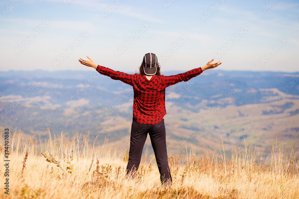 Lifestyle happy young traveling carefree woman with raised hands admire beautiful mountains Lifestyle happy young traveling carefree woman with raised hands admire beautiful mountains