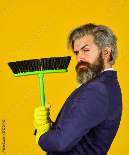 On guard of order. Cleaning day. Cleaning business. Household duties. Cleaning service concept. Clear reputation. Bearded man formal suit hold broom brush. Sweep in office. Hipster enjoy cleanliness