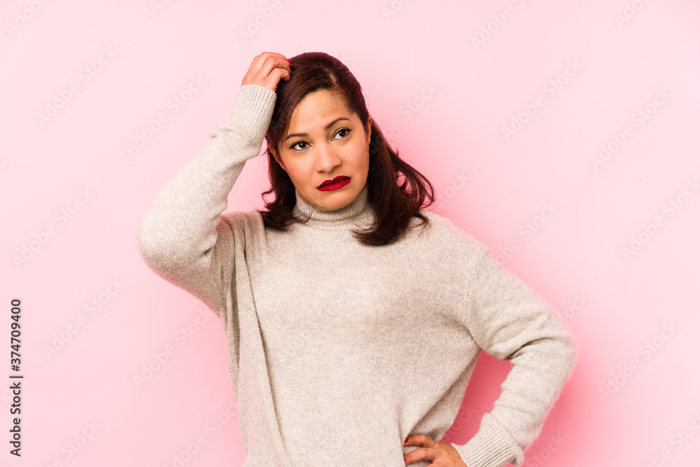 Middle age latin woman isolated on a pink background being shocked, she has remembered important meeting. Middle age latin woman isolated on a pink background being shocked, she has remembered important meeting.