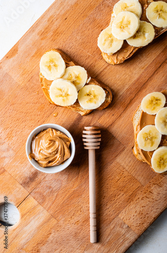 breakfast with peanut butter and banana sandwiches served on a wooden board