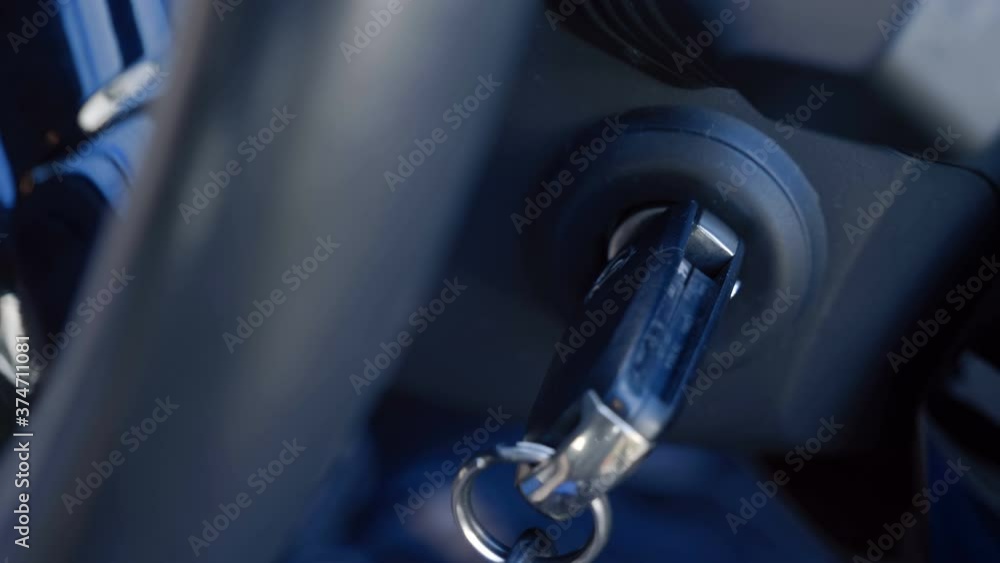 The driver inserts the ignition key into the ignition lock, turns it