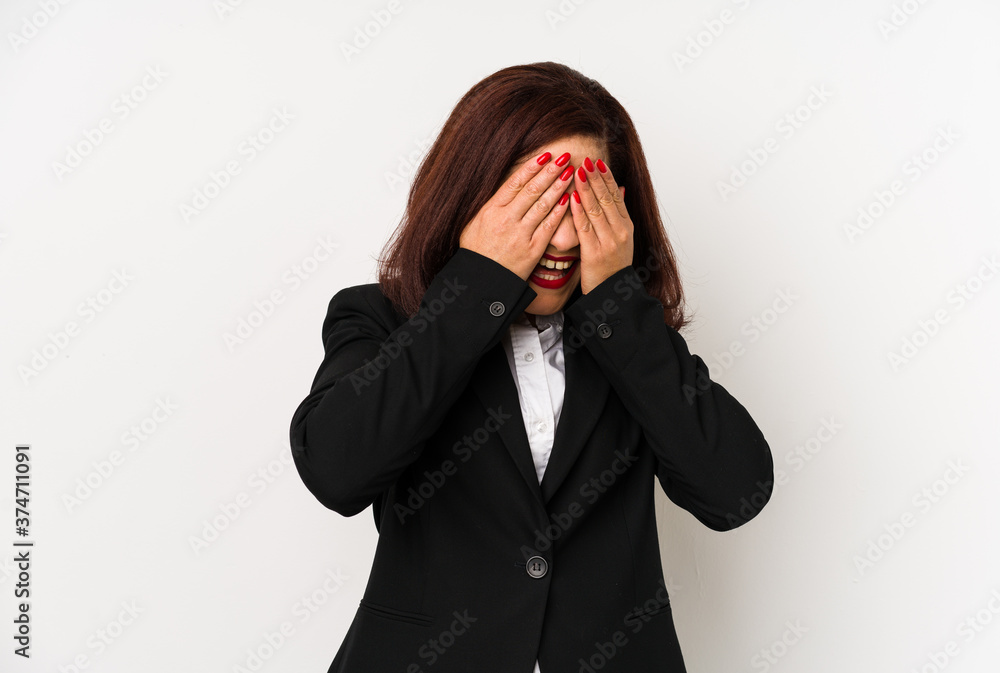 Middle age latin business woman isolated covers eyes with hands, smiles broadly waiting for a surprise.