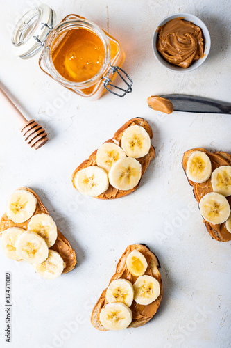 sweet sandwiches with banana and nut butter on a light table