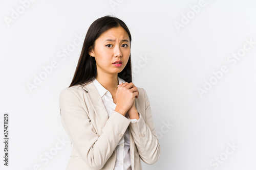 Young chinese business woman isolated scared and afraid.