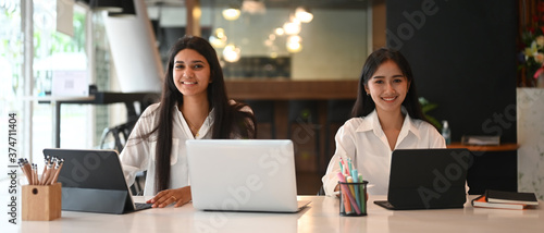 Wallpaper Mural The young graphic designer team are working together with a computer laptop and tablet at the modern working desk Torontodigital.ca