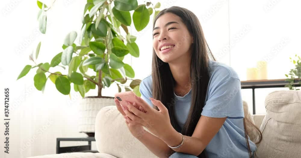 Happy woman chatting using mobile phone at home Happy woman chatting using mobile phone at home