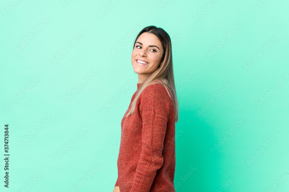 Fototapeta premium Young caucasian woman isolated looks aside smiling, cheerful and pleasant.