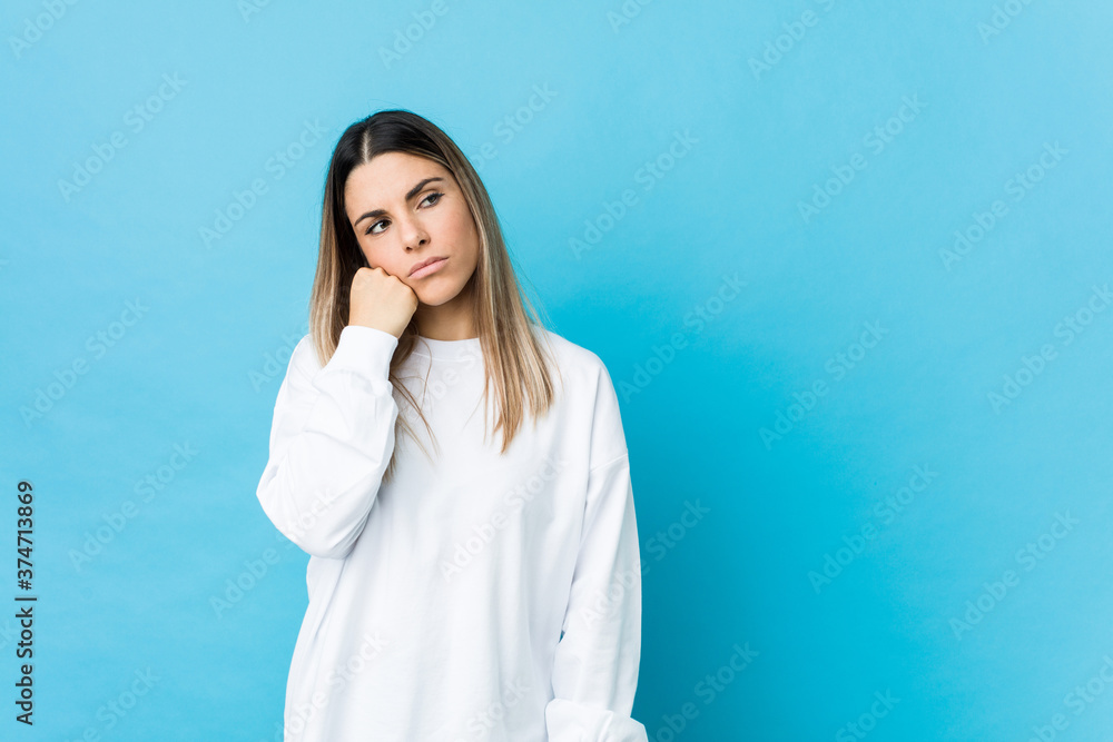 Young caucasian woman isolated who feels sad and pensive, looking at copy space. Young caucasian woman isolated who feels sad and pensive, looking at copy space.