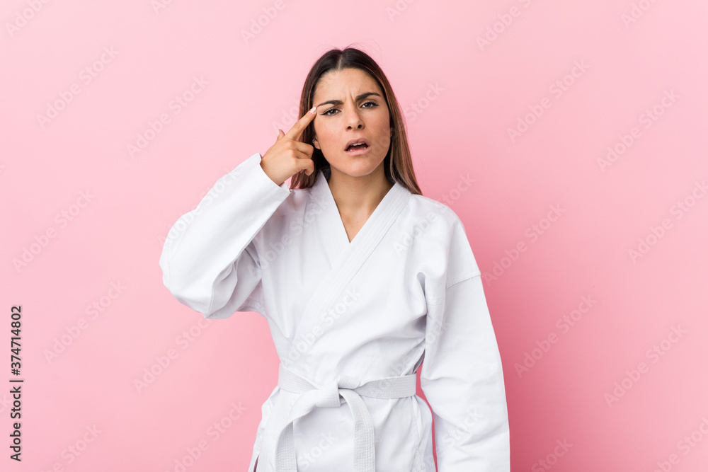 Young karate woman showing a disappointment gesture with forefinger. Young karate woman showing a disappointment gesture with forefinger.