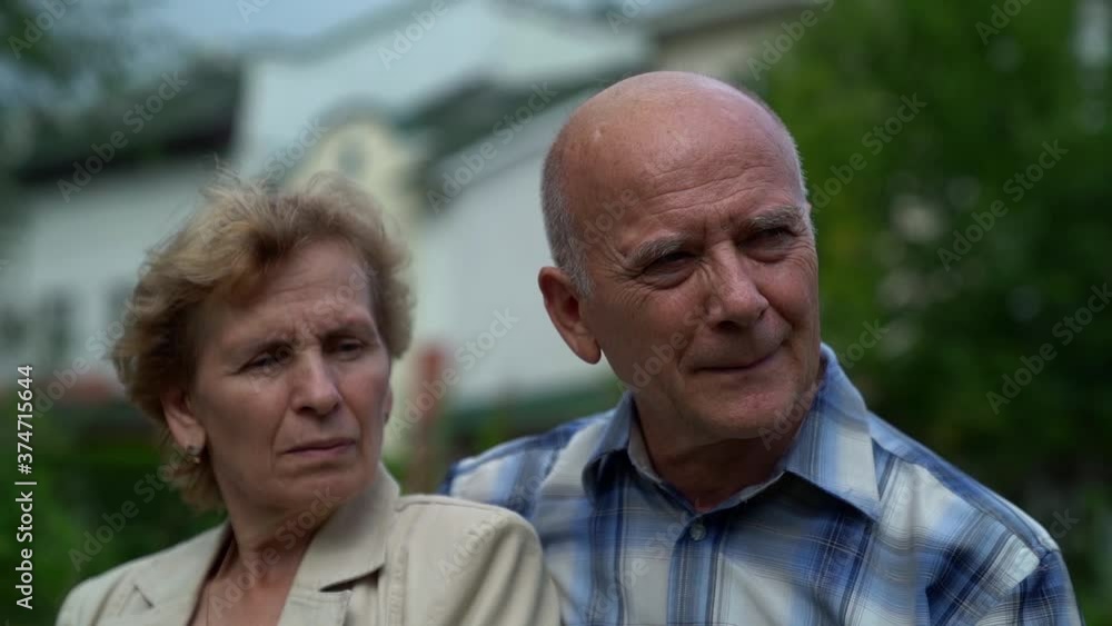 Caucasian couple elderly tired people walking on the street Caucasian couple elderly tired people walking on the street
