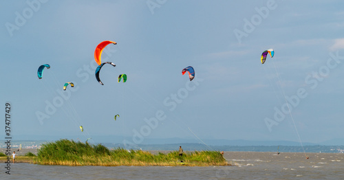 Power kites in the sky above the water, equipment for kiteboarding or kitesurfing photo