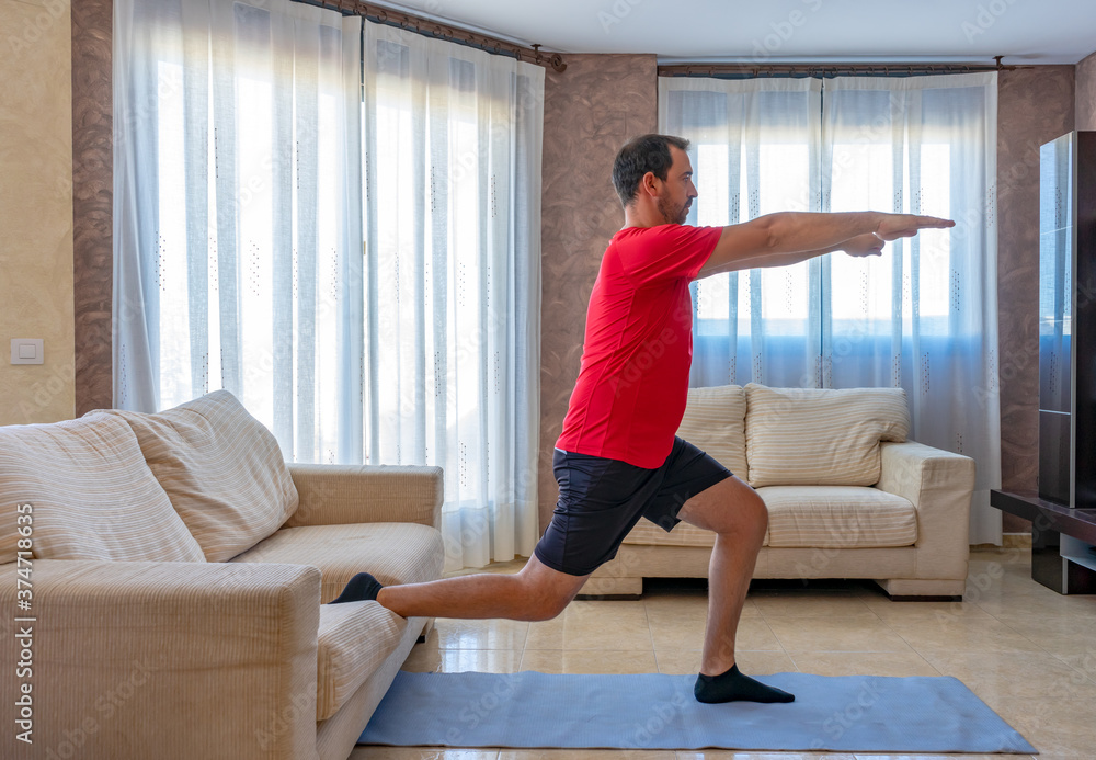 Bearded man in low shape exercising with black and red sportswear