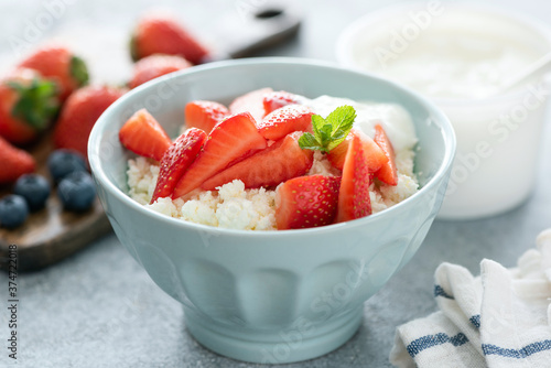 Cottage cheese with strawberries in a bowl. Sustainable food, healthy diet dairy food rich in calcium and protein