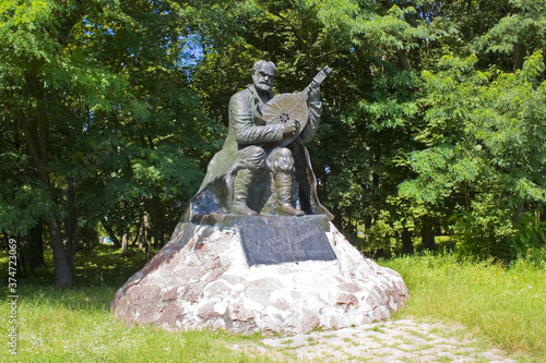 Monument to the kobzar Ostap Veresay near Palace of  Galagans in Sokirintsy in Ukraine photo
