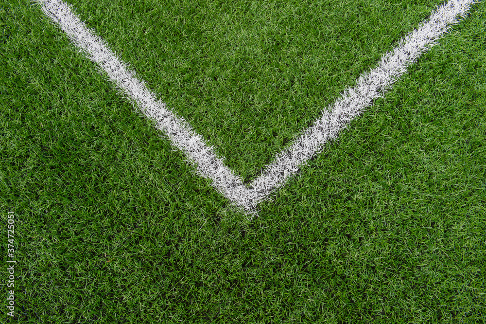 Green synthetic grass sports field with white line shot from above. Soccer, rugby, football, baseball sport concept