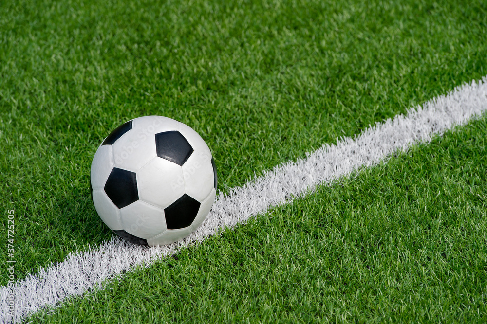Fototapeta premium Black and white soccer ball in the field. Team sport concept. Workout online theme.