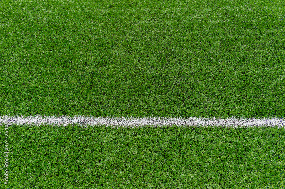 Green synthetic grass sports field with white line shot from above. Soccer, rugby, football, baseball sport concept Green synthetic grass sports field with white line shot from above. Soccer, rugby, football, baseball sport concept