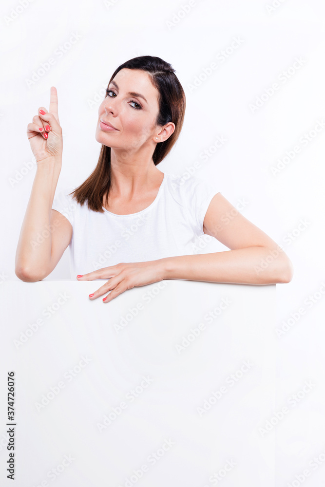 Young woman holding a signboard and pointing Young woman holding a signboard and pointing