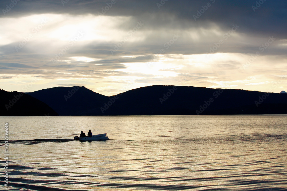 Boat on water with Midnight sun Mo I Rana Norway Boat on water with Midnight sun Mo I Rana Norway