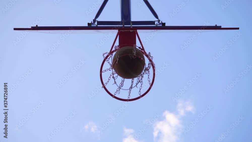 Close-up Basketball Hoop. Orange Ball Flies Into Basketball Hoop, Slow Motion Close-up Basketball Hoop. Orange Ball Flies Into Basketball Hoop, Slow Motion