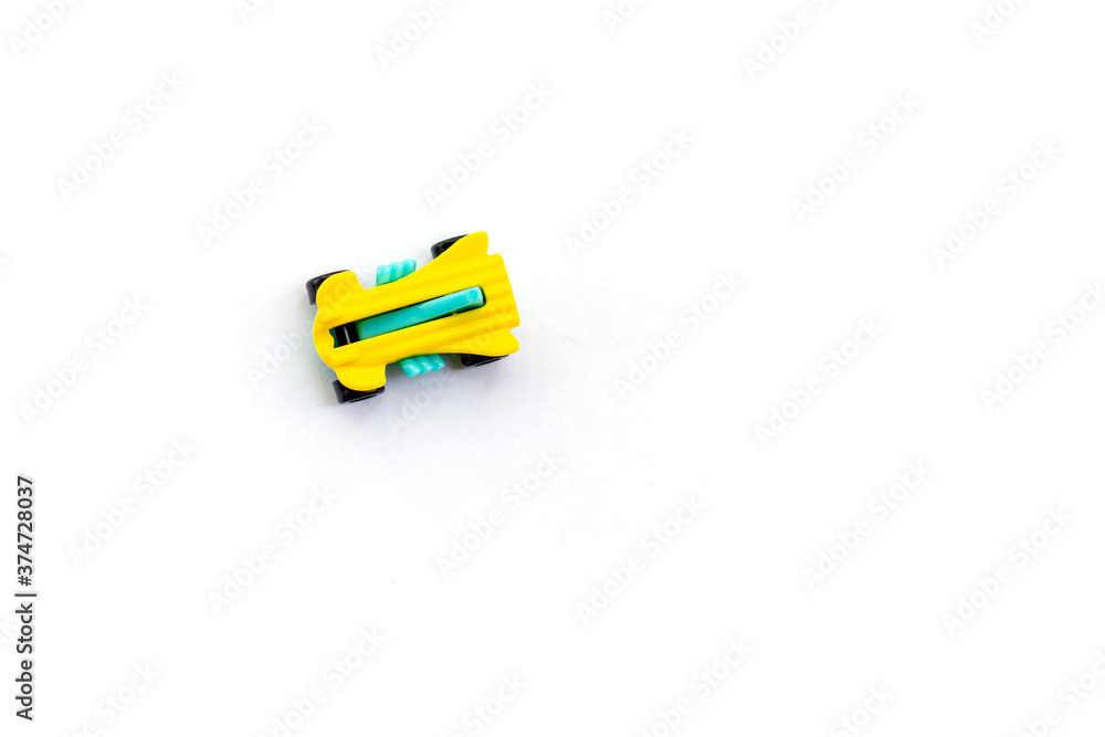 Isolated object small plastic racing car for children top view on white background space for text