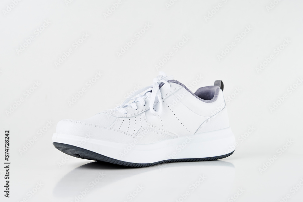 White male sneaker on white background isolated. Fashion stylish sport shoes, close up