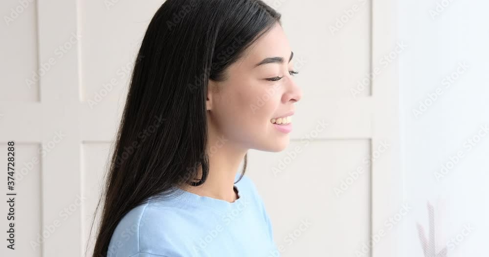 Beautiful korean woman looking out through window at home Beautiful korean woman looking out through window at home