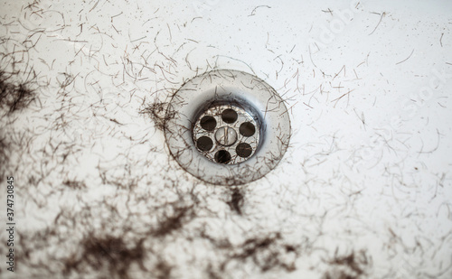 Shaved hairs in the washbasin with razor and trimmer. Hairdresser tools