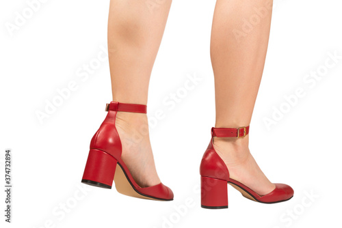 Woman legs in retro red sandals on heels.